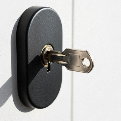 Close-up of a broken key stuck in a modern door lock
